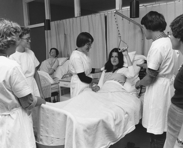 828095 Afbeelding van enkele leerling-verpleegkundigen tijdens een praktijkles van de A-opleiding ziekenverpleging in ...